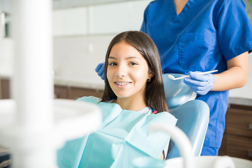 portrait-smiling-teenage-girl-with-braces-sitting-chair-while-dentist-standing-clinic zoom